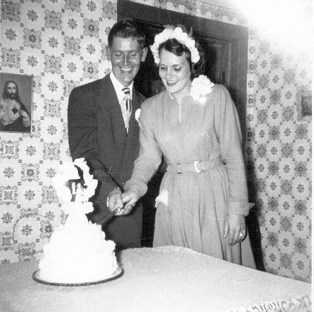 R. V. and Betty Baxter cutting their wedding cake.